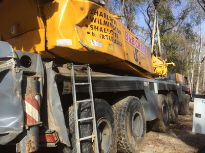 Export Logistics & Shipping, Inc. Liebherr LTM1250 crane is rescued with dented sides